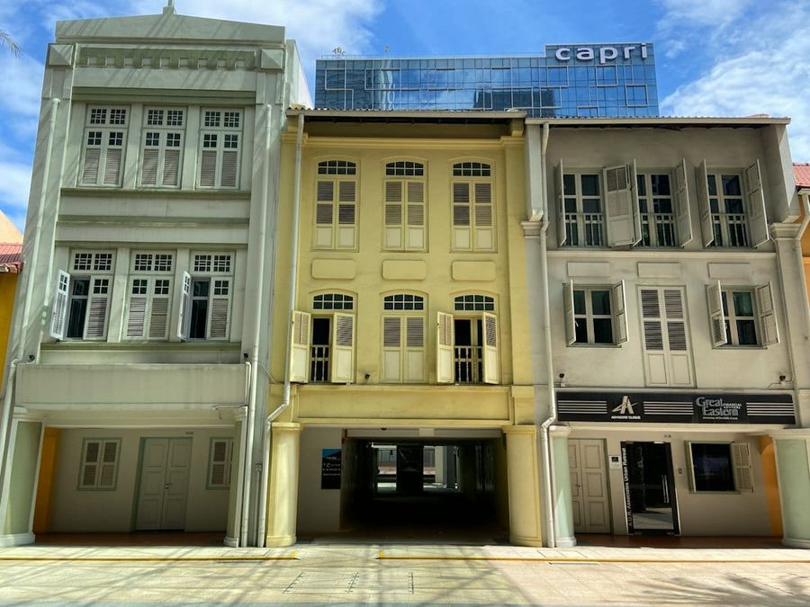 Heritage shophouses along a quiet tree-lined street in Katong, Singapore